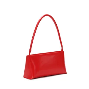 Red leather baguette shoulder bag detailed view, stylish minimalist fashion handbag for women.