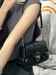 Black motorcycle baguette underarm shoulder bag with chic metal chain and buckle straps.