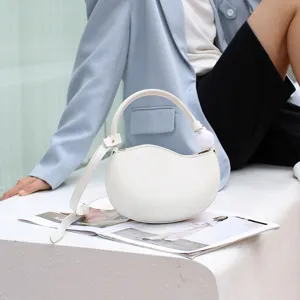 White PU leather crescent shoulder crossbody bag, stylish niche design candy color pea bag for women.