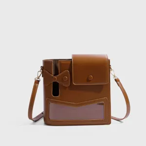 Brown PU leather water bottle shoulder bag detail, transparent window storage pocket.