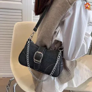 Stylish denim shoulder bag for women, trendy chain baguette bag with vintage metal buckle design.