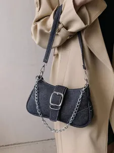 Stylish denim shoulder bag detail, vintage metal chain and buckle design, chic everyday accessory.