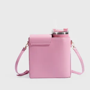 Pink water bottle crossbody bag with tumbler holder, stylish commuter shoulder bag for outdoor use.