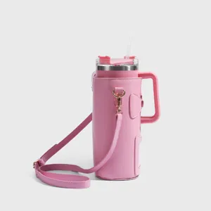 Pink large capacity insulated tumbler with leather strap carrier bag and straw for outdoor travel.