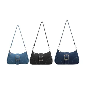Denim shoulder bag for women, stylish underarm baguette bag with metal buckle design.