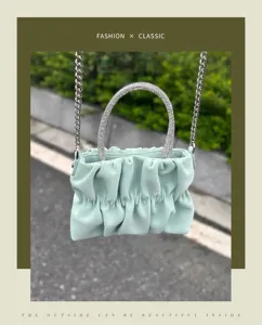 Green ruched cloud handbag with rhinestone handle and chain strap for stylish women.