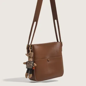 Chic brown shoulder bag with cute rabbit pendant, stylish everyday crossbody bag for women.