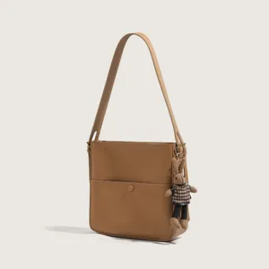 Chic minimalist shoulder bag for women, versatile brown commuting crossbody bucket bag.