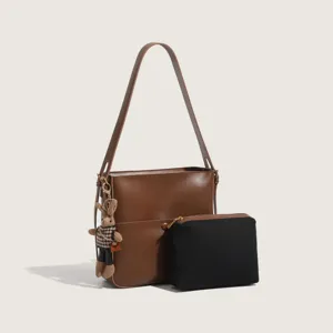 Chic brown leather bucket bag set with black pouch and cute bear pendant for women stylish daily wear