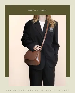 Stylish vintage brown saddle bag with clean minimalist design, detail view of crossbody strap.