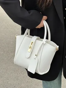 White litchi grain leather handbag detail showcasing metal clasp closure and structured design.