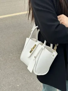 Detail view of the stylish pebble leather bucket handbag with elegant gold metal lock closure.