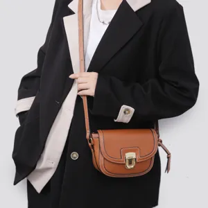 Trendy retro brown leather saddle bag for women, versatile crossbody shoulder bag for daily wear.