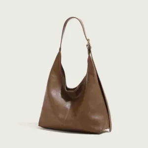 Detailed close-up view of the elegant brown leather shoulder bag, highlighting texture.