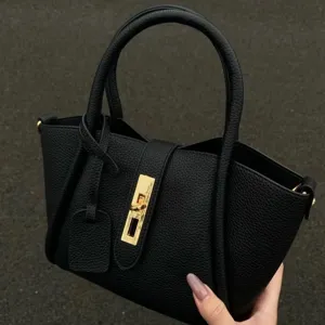 Black litchi grain soft leather handbag, stylish top-handle tote with golden hardware lock.