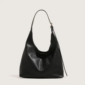 Black leather hobo shoulder bag featuring minimalist design, spacious interior, and adjustable strap.