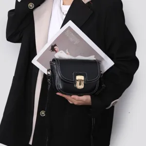 Chic black saddle bag with contrast white stitching and gold clasp, perfect stylish everyday accessory.