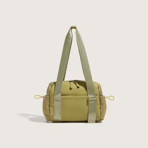 Green nylon shoulder bag and gym tote with mesh side pockets, perfect for travel and sports.