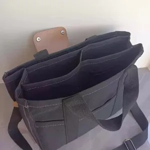Canvas tote bag interior detail view, showing multi-compartment storage capacity and design.