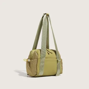 Nylon shoulder bag detail, olive green sports gym bag with mesh side pockets and long straps.