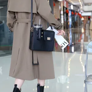 Black crossbody water bottle bag with tumbler holder and strap for outdoor travel convenience.