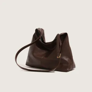 Close-up of a retro dark brown slouchy shoulder bag, featuring soft leather and adjustable strap.