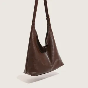 Dark brown hobo shoulder bag detail, minimalist design, casual daily wear style.