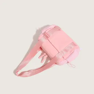 Detailed close-up showing the smooth zipper, durable nylon fabric and wide shoulder strap of this pink bag.
