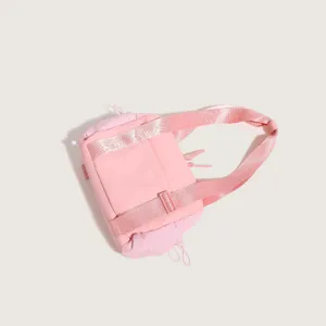 Close-up detail of the pink nylon sports fitness bag showing textured strap and fabric.