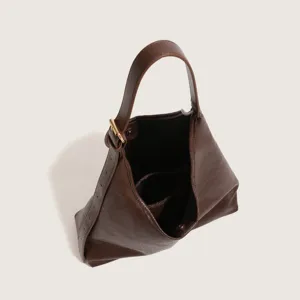 Brown leather shoulder bag interior and handle detail, minimalist daily commute design.