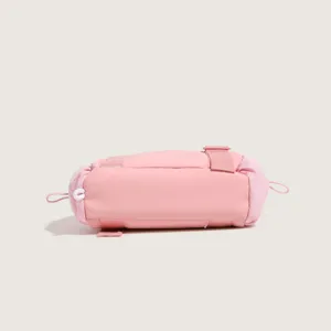 Pink nylon cylinder travel gym bag detail view, compact storage pouch for daily fitness essentials.