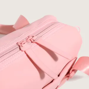 Close-up detail of the pink nylon sports gym bag zipper and durable strap design.