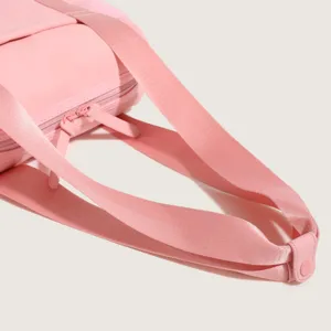 Pink nylon sports fitness bag detail shot, large capacity casual shoulder tote bag for travel.