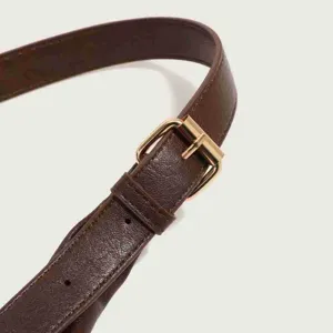Detailed shot of dark brown PU leather shoulder bag strap with gold metal buckle, stylish daily bag.