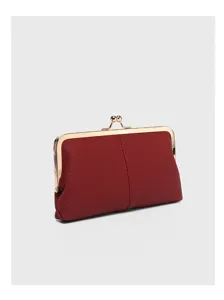 Red genuine leather kiss-lock coin purse close-up, retro metal frame clutch wallet.
