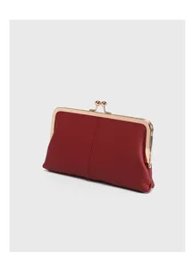 Detail view of the red leather kiss-lock clutch, showcasing soft texture and gold frame.