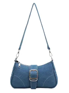 Classic blue denim shoulder bag for women, stylish underarm baguette handbag with metallic buckle.