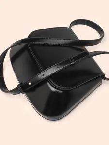 Minimalist black leather saddle bag, elegant stylish crossbody bag for daily fashion wear.
