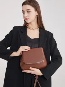 Retro chestnut brown saddle bag for women, stylish minimalist leather crossbody shoulder bag.