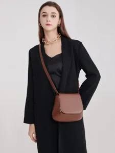 Retro brown saddle bag for women, versatile PU leather crossbody bag, minimalist chic design.