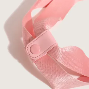 Pink nylon strap and buckle detail of sports fitness travel bag accessory close-up