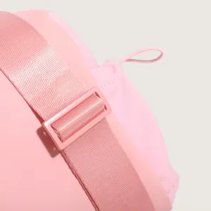 Close-up detail of the pink nylon sports bag strap, adjustable buckle and drawstring.