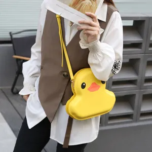 Close-up detail of the cute yellow duck hard shell crossbody bag, fashion cartoon style accessory.