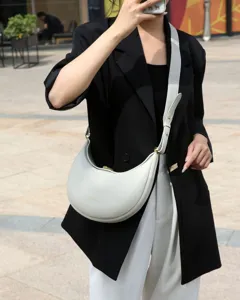 Grey leather crescent hobo bag stylish minimalist crossbody shoulder bag for women daily commute.