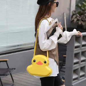 Cute yellow duck shell shoulder bag for women, cartoon crossbody bag with adjustable strap.