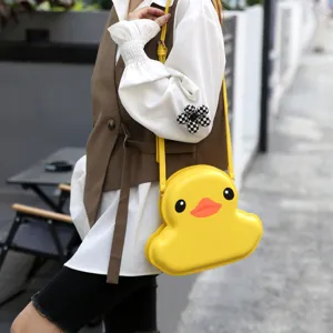 Detailed view of the cute yellow duck shaped shell crossbody bag with adjustable strap.