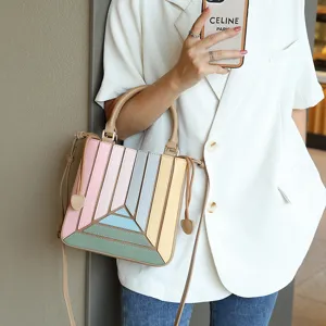 Detailed shot of the stylish color-block handbag with geometric design and shoulder strap.