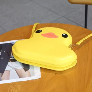 Yellow duck hard shell crossbody bag detail showing cute cartoon design and shoulder strap.
