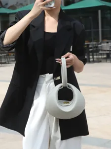 Chic designer ring handle crescent shoulder bag, stylish commuter handbag for women.