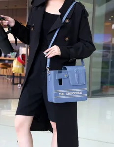 Detailed view of the blue crocodile pattern water bottle bag with stylish structured design.